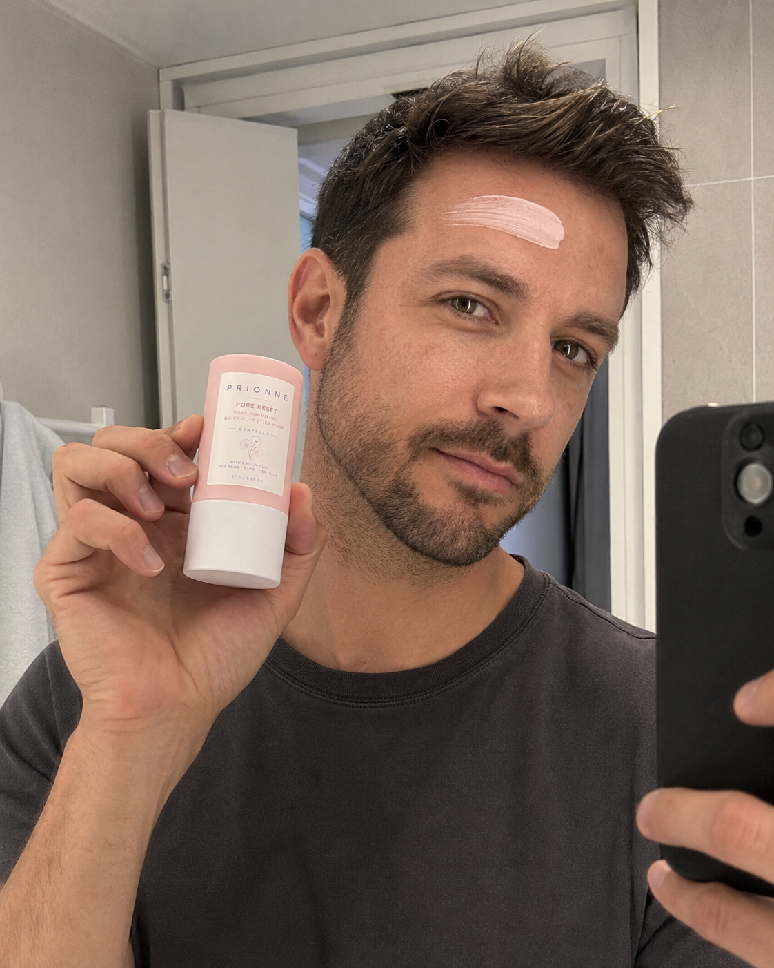 Male customer mirror selfie using Prionne clay mask stick